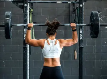 Gritty young woman getting ready to powerlift.
