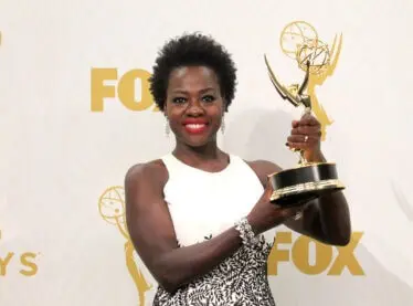 Viola Davis holding her Emmy. She also made a bold choice to take off her wig and makeup.