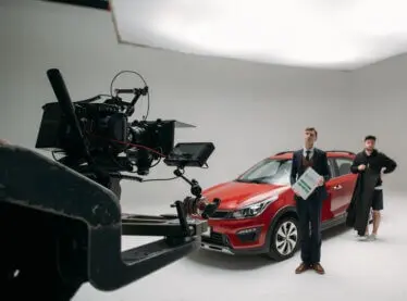 Actor in a nice suit filming a car commercial.