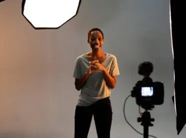 An actress in front of a camera auditioning for a role.