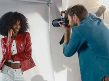 An African actress getting her headshots taken by a photographer.