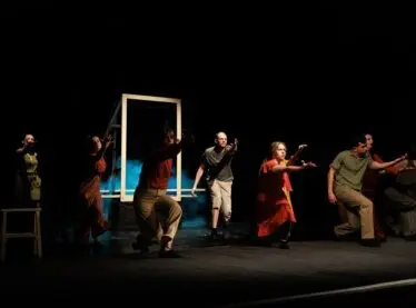 Various stage actors performing in a play.
