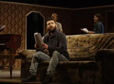 Actors on a set preparing their lines.