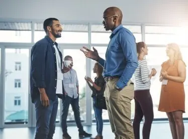 A group of young people chatting at a networking event.