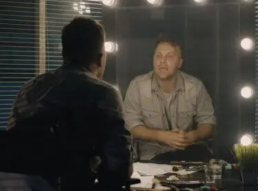 An actor warming up in the dressing room.