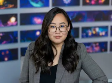 Casting Director Grace Kim smiling in a Disney casting office lobby.