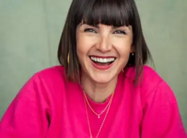 Kahleen Crawford in a pink sweater smiling.