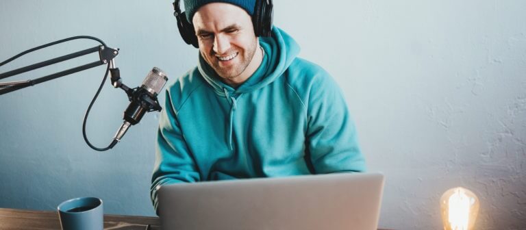 Happy,Man,Streaming,His,Audio,Podcast,At,Cozy,Home