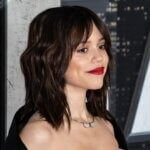 Jenna Ortega attending an event in front of a black and white backdrop.