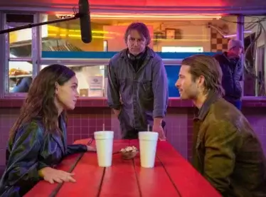 Adria Arjona, Richard Linkletter, and Glen Powell on the set of the film ‘Hit Man.’