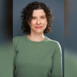 Casting director Kate Geller smiling in a green sweater.