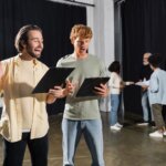Actors reviewing their audition books.