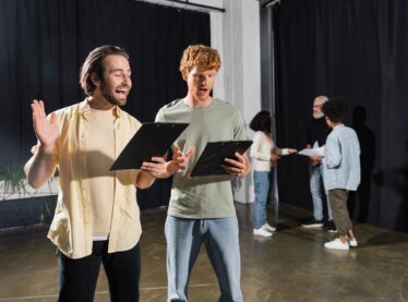 Actors reviewing their audition books.