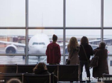 Actors waiting on the runway at an airport in winter staring at a stationed plane.