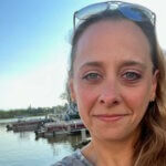 Selfie of casting director Maribeth Fox smiling outside by the water.